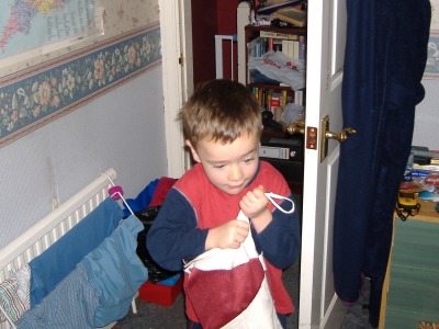 Bringing the stocking into Mummy & Daddy's room.